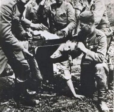 Grupa chorwackich zbrodniarzy (oddziały ustaszów) w trakcie mordowania Serba piłą do drewna, 1941